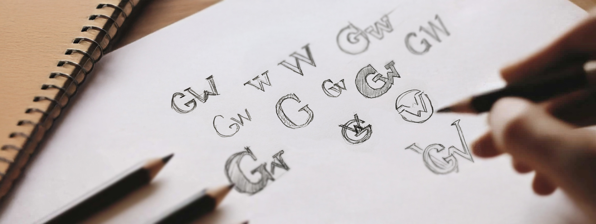 Rough sketches of logo concepts featuring letters G and W, GW logo, showcasing early stages of logo design exploration